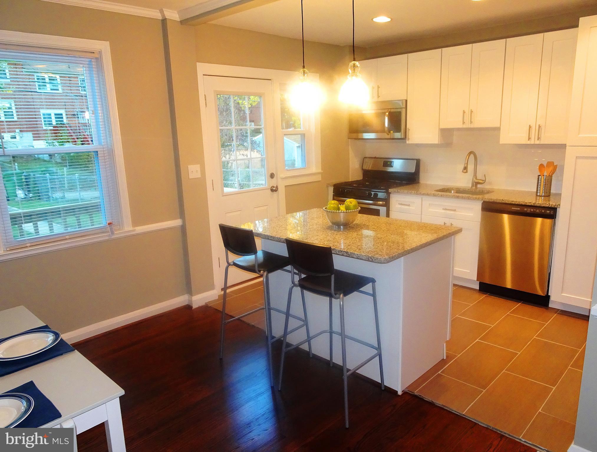 1406 Meridene Drive Baltimore, MD 21239 - Photo 29 of 30 a kitchen with stainless steel appliances granite countertop a sink counter space and a large window