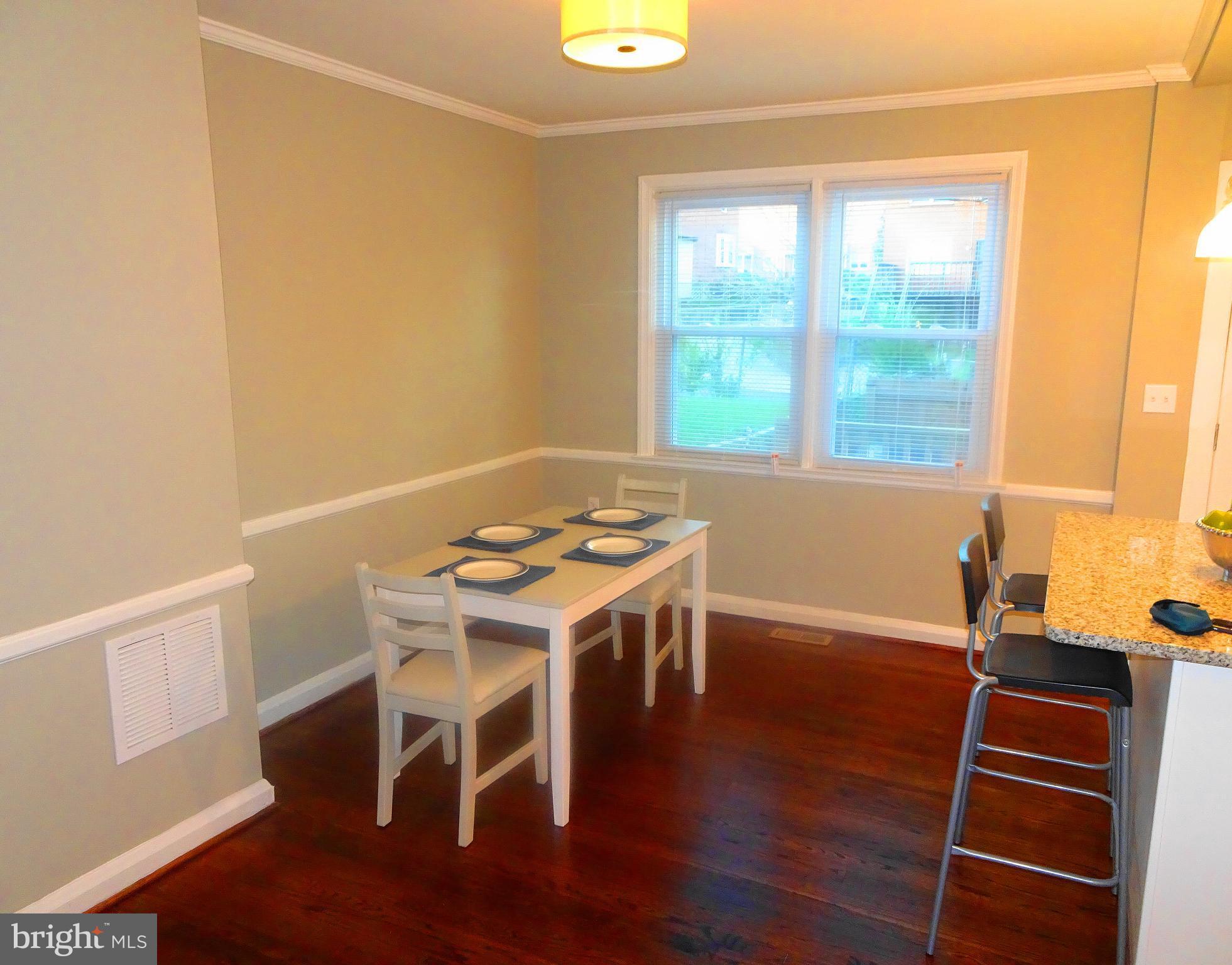 1406 Meridene Drive Baltimore, MD 21239 - Photo 9 of 30 a view of a dining room with furniture window and wooden floor