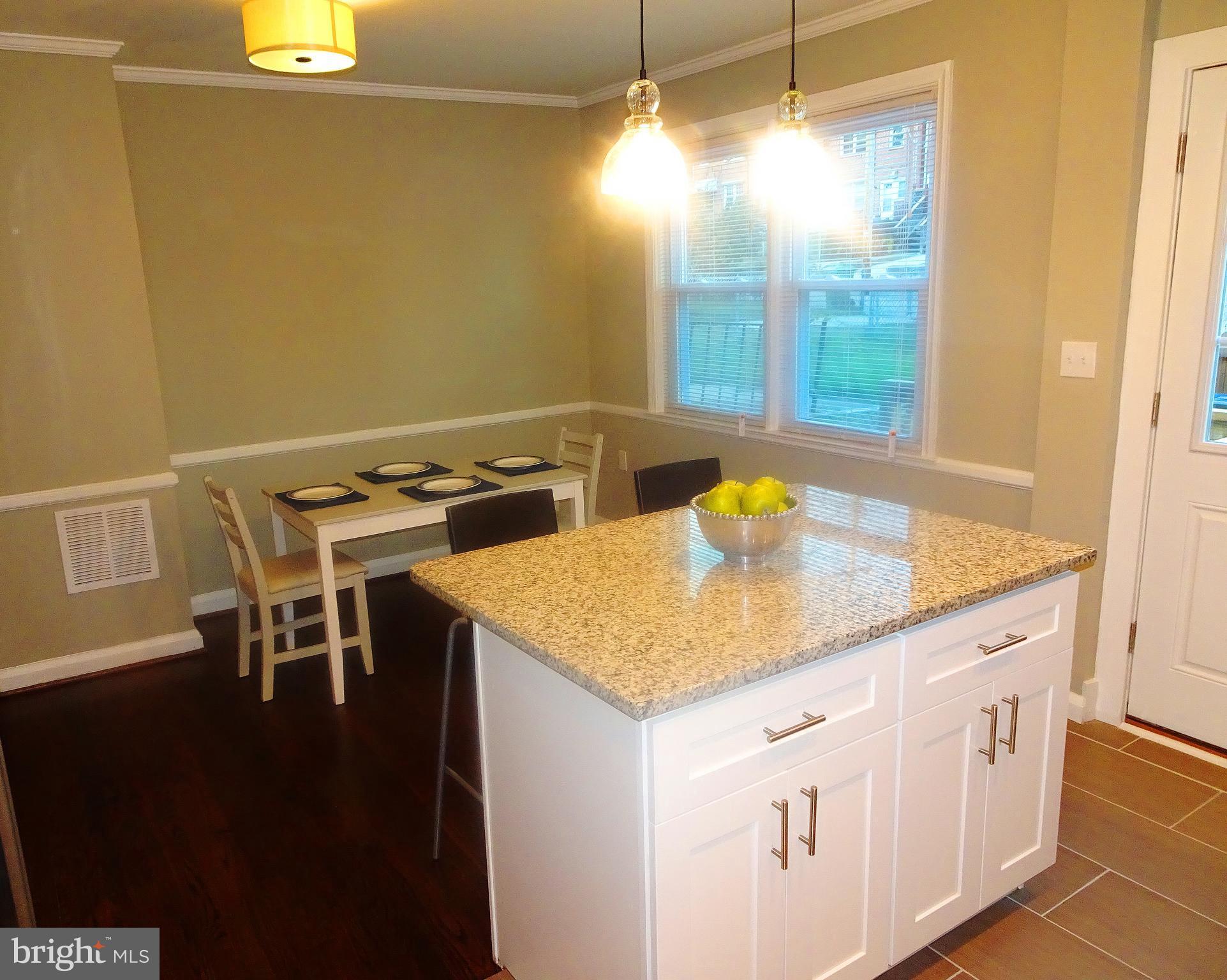 1406 Meridene Drive Baltimore, MD 21239 - Photo 30 of 30 a kitchen with a sink a stove a dining table and chairs