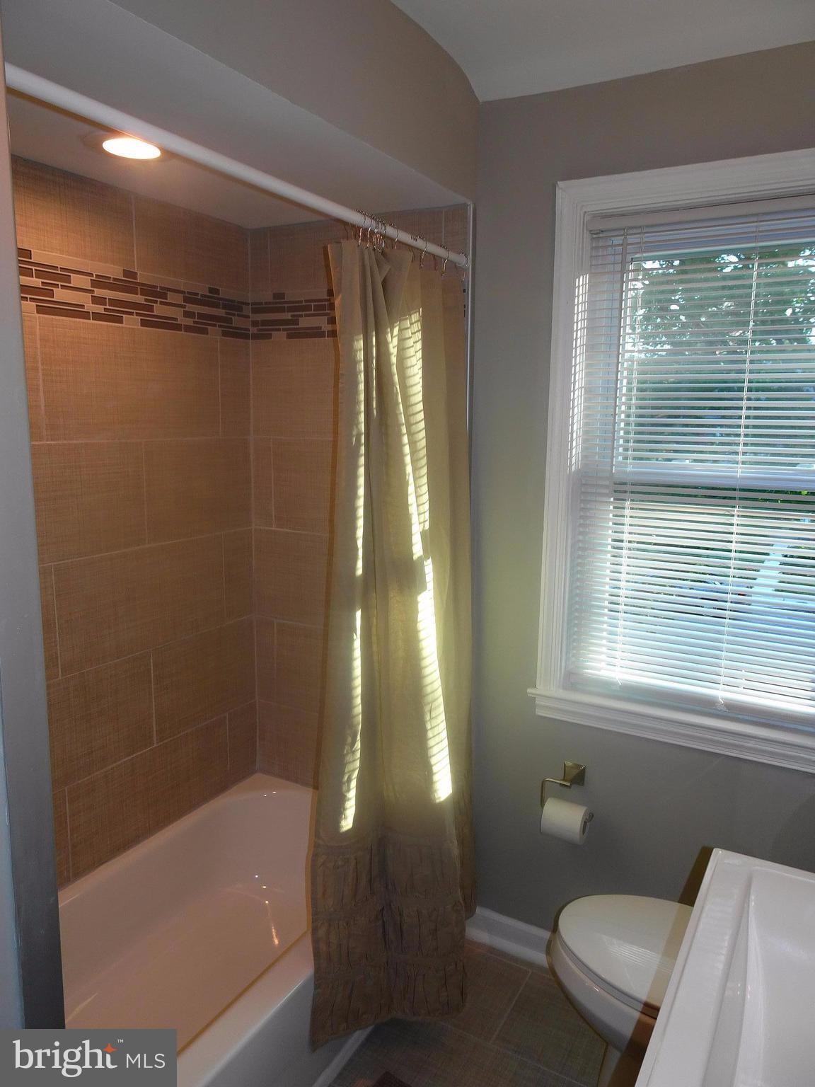 1406 Meridene Drive Baltimore, MD 21239 - Photo 11 of 30 a bathroom with a bathtub and a shower