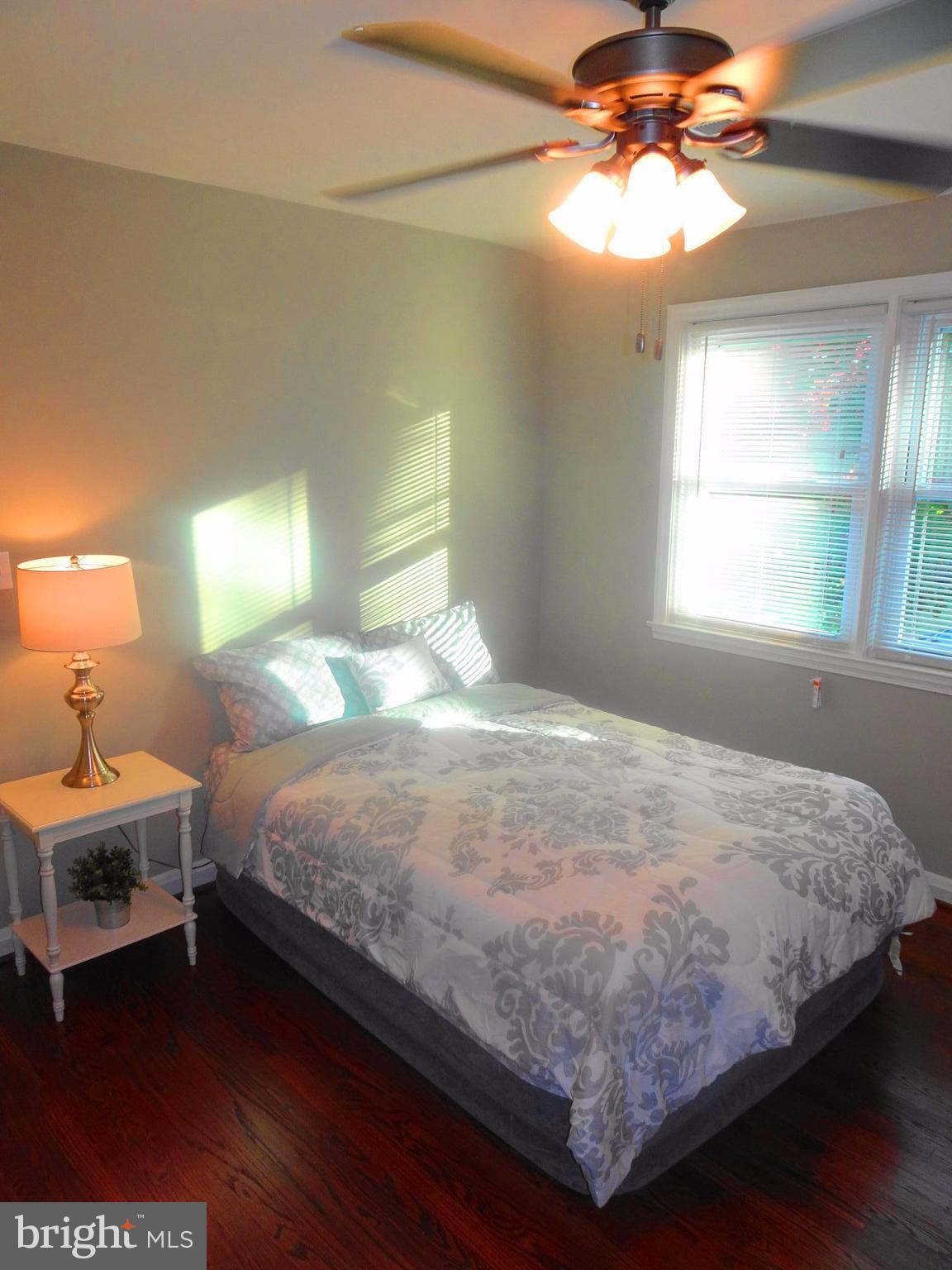 1406 Meridene Drive Baltimore, MD 21239 - Photo 14 of 30 a bedroom with a bed and a chandelier