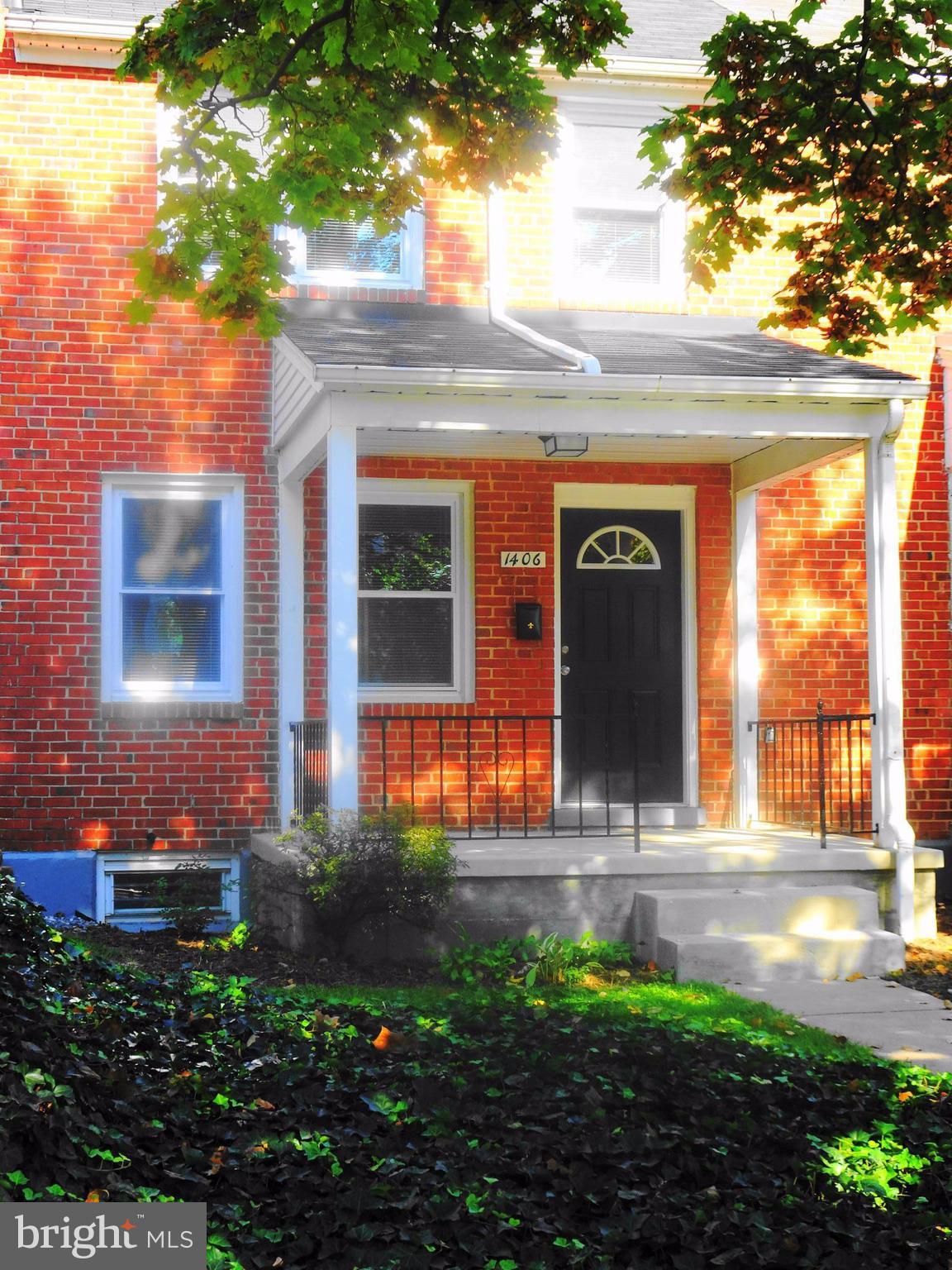 1406 Meridene Drive Baltimore, MD 21239 - Photo 1 of 30 a front view of a house with a yard