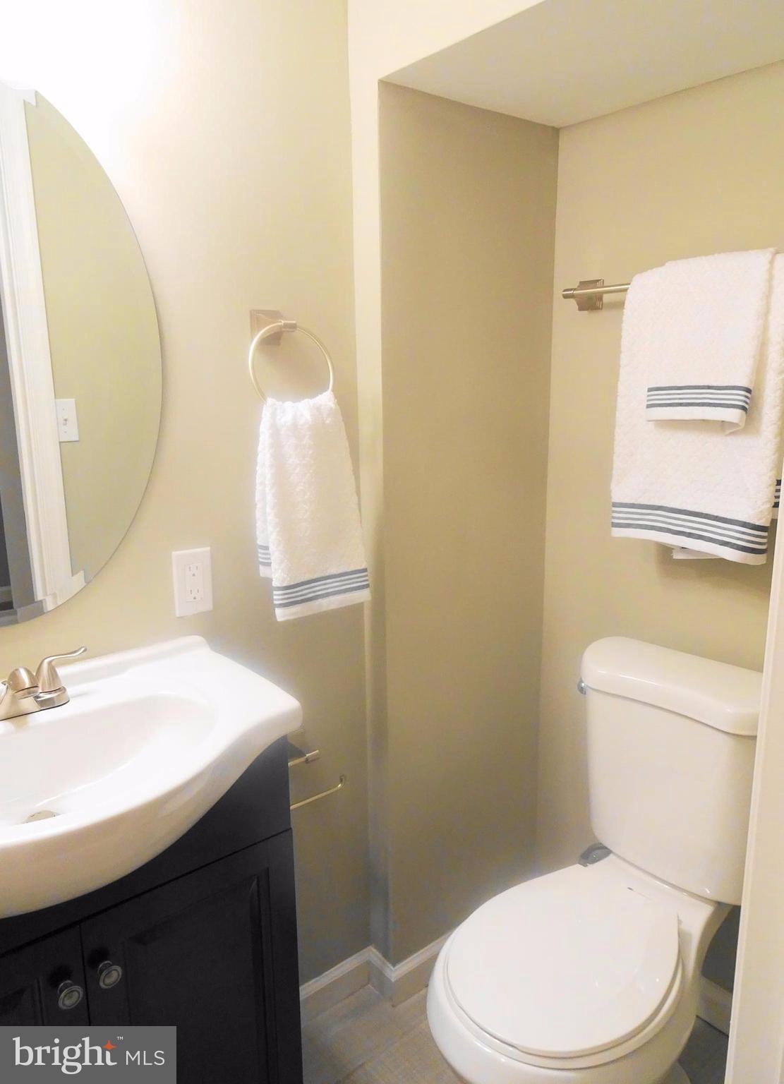 1406 Meridene Drive Baltimore, MD 21239 - Photo 23 of 30 a white toilet sitting next to a bathroom sink