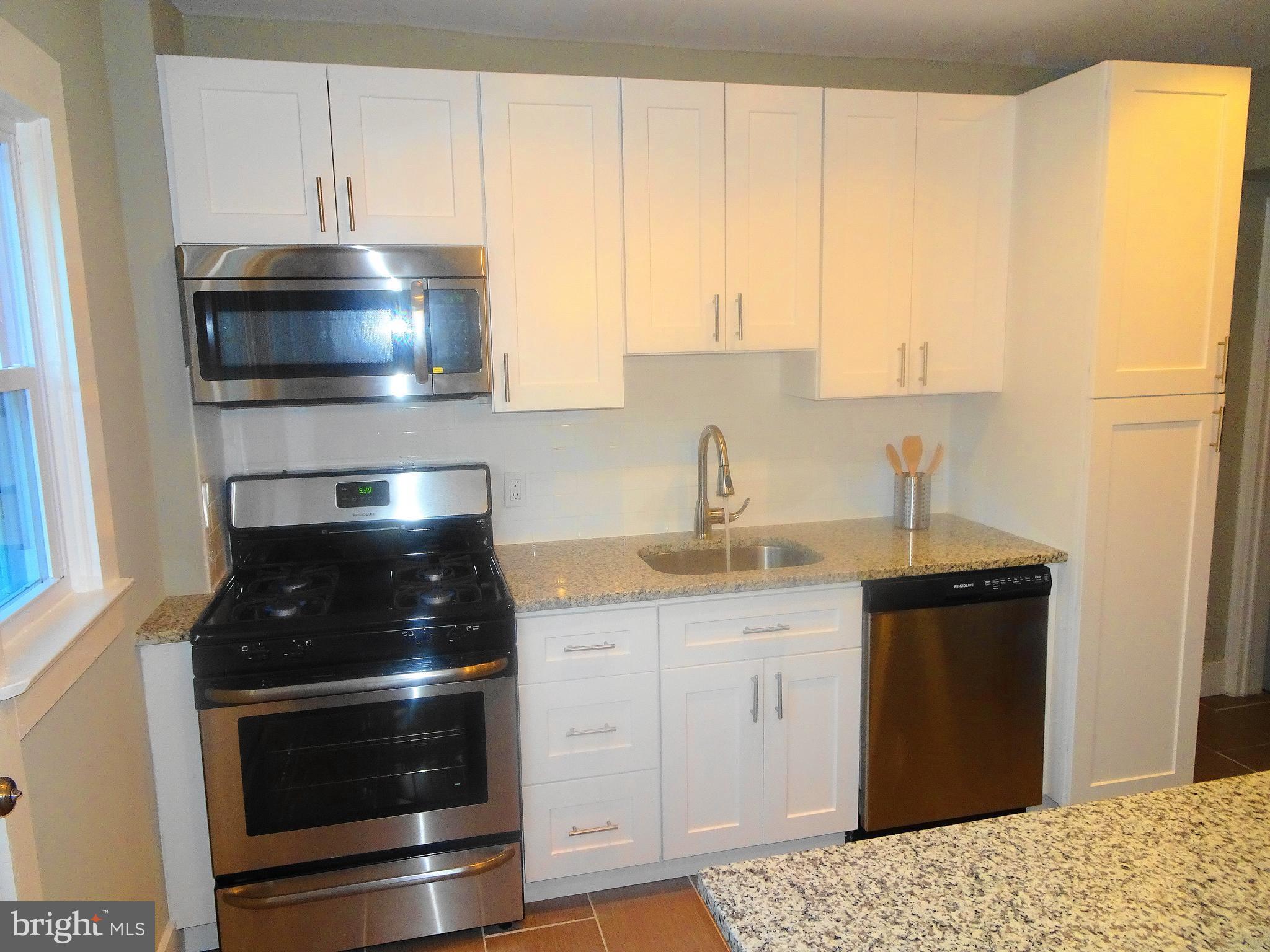 1406 Meridene Drive Baltimore, MD 21239 - Photo 4 of 30 a kitchen with a sink and a stove
