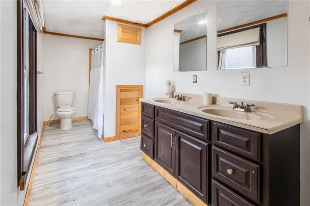 a en suite bathroom with a sink double vanity and a toilet
