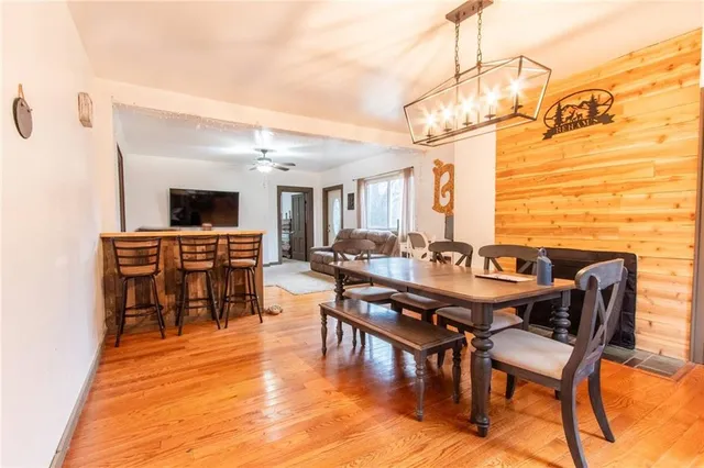 a dining room with furniture and wooden floor