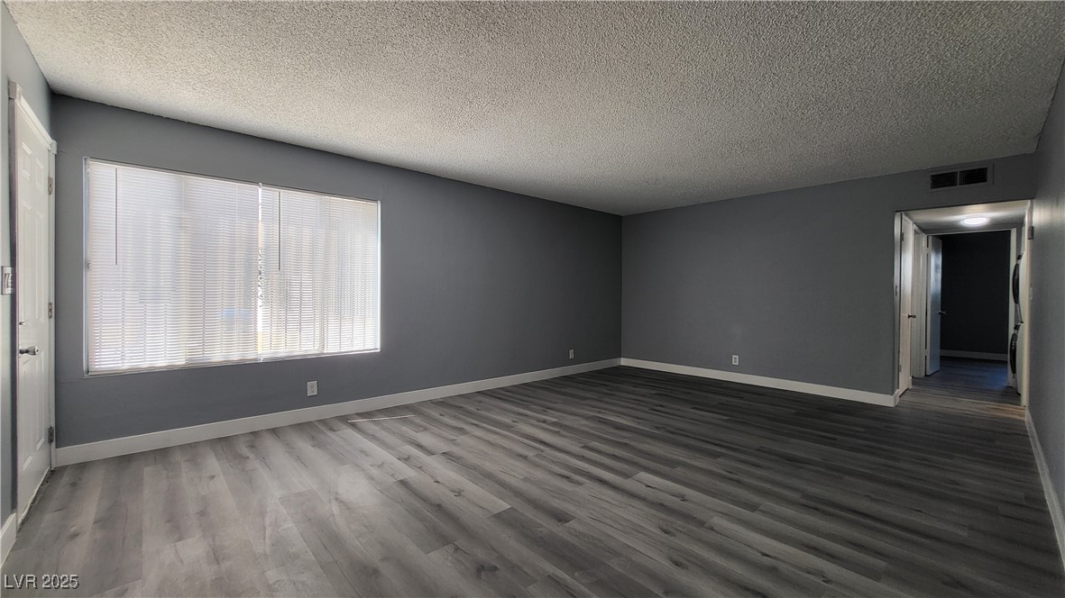 3240 Michael Way, Unit 3 Las Vegas, NV 89108 - Photo 4 of 22 Spare room with a textured ceiling and dark wood-type flooring