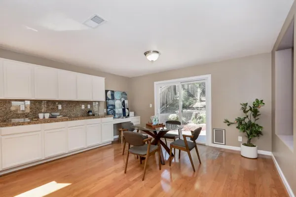 a kitchen with a table and chairs in it