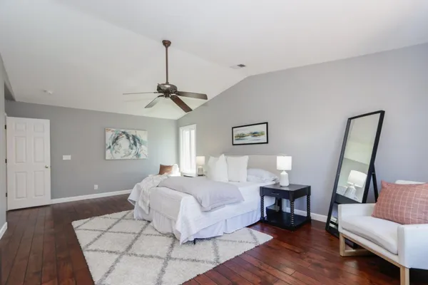 a spacious bedroom with a bed and a couch