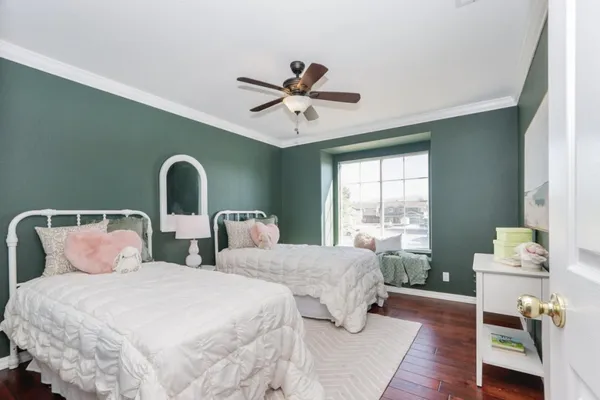 a bedroom with two beds and a large window