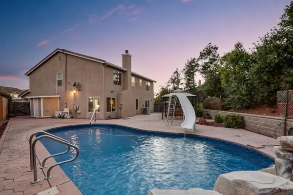 a view of a swimming pool with a patio
