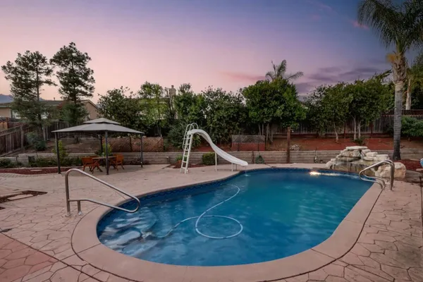 a view of a swimming pool with sitting area