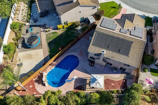 an aerial view of a house with yard