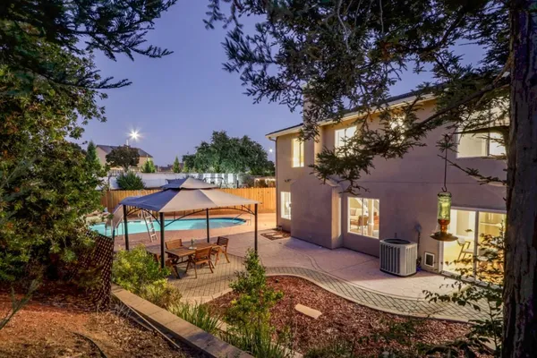 a view of a house with backyard porch and sitting area