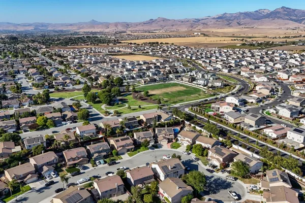 an aerial view of a house with a yard