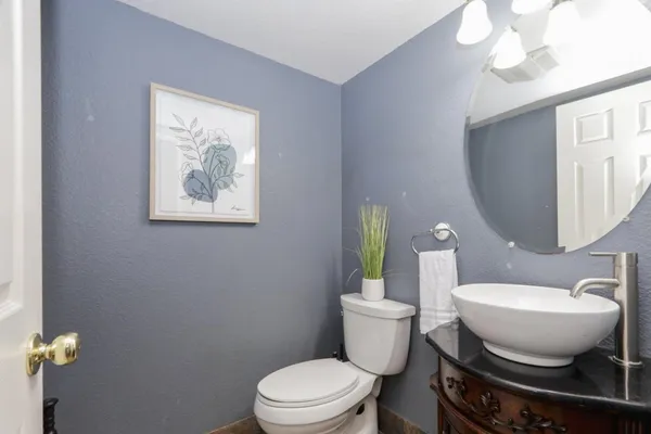 a bathroom with a toilet a sink and mirror