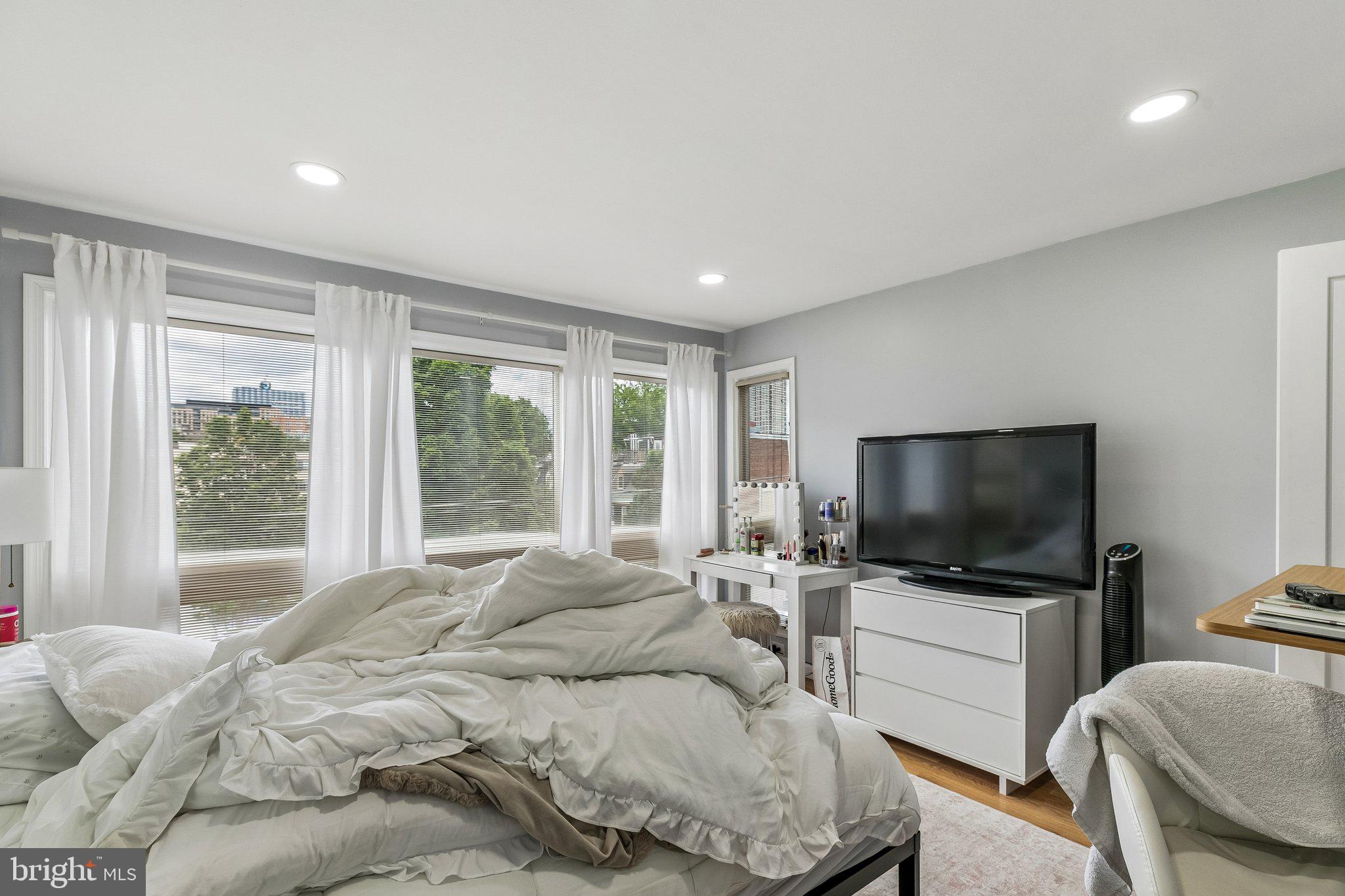 1130 Lombard Street Philadelphia, PA 19147 - Photo 23 of 45 a bedroom with a bed television window and a flat screen television