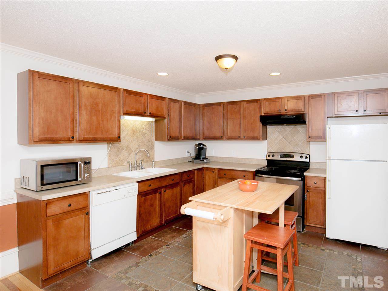 3628 Edgemont Road Wendell, NC 27591 - Photo 2 of 17 a kitchen with granite countertop a sink stove and refrigerator