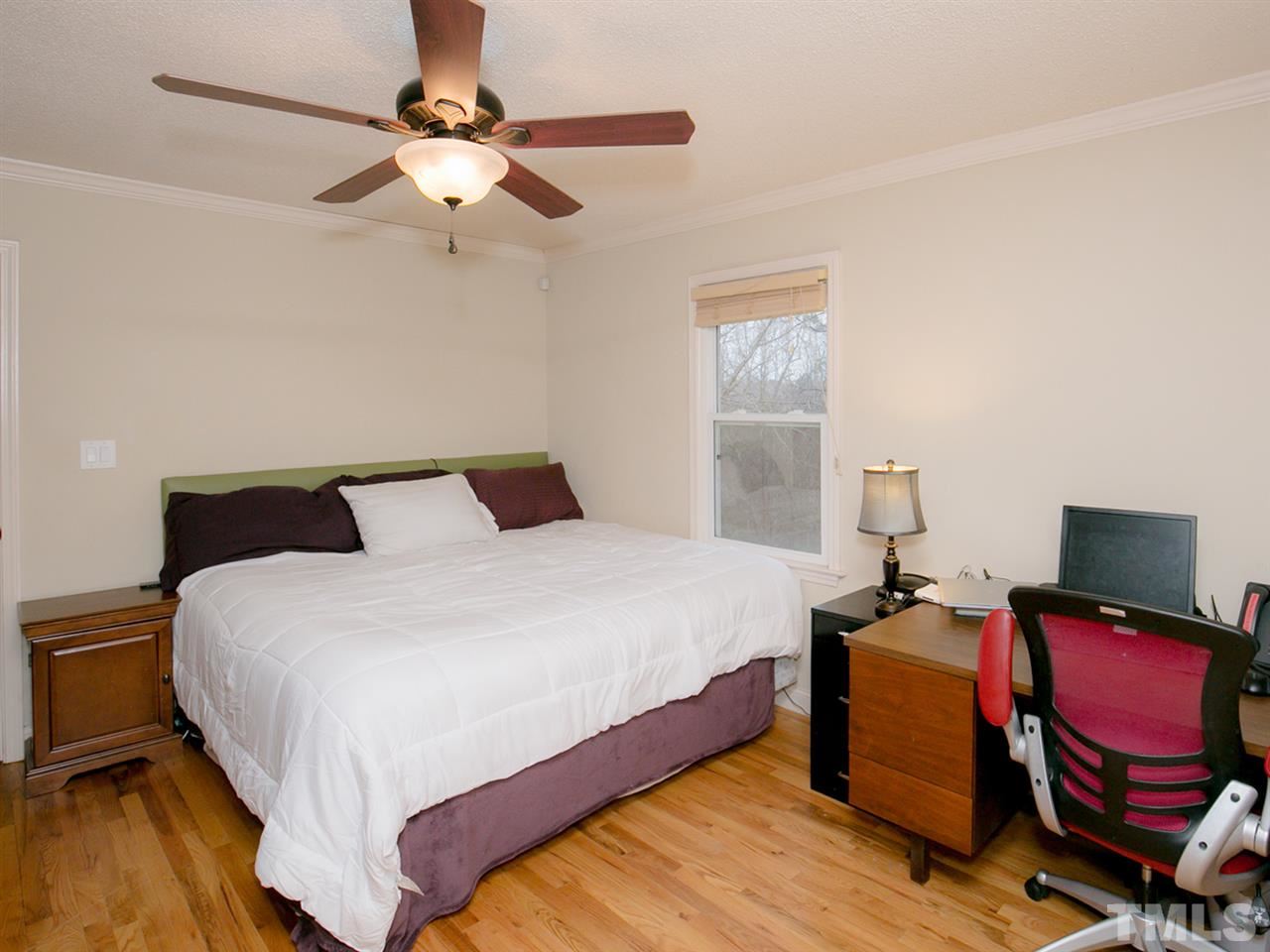 3628 Edgemont Road Wendell, NC 27591 - Photo 11 of 17 a bedroom with a bed and wooden floor