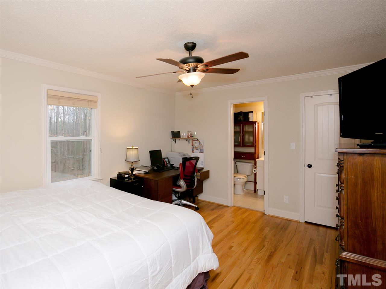 3628 Edgemont Road Wendell, NC 27591 - Photo 12 of 17 a bedroom with a bed and a flat tv screen on the dresser