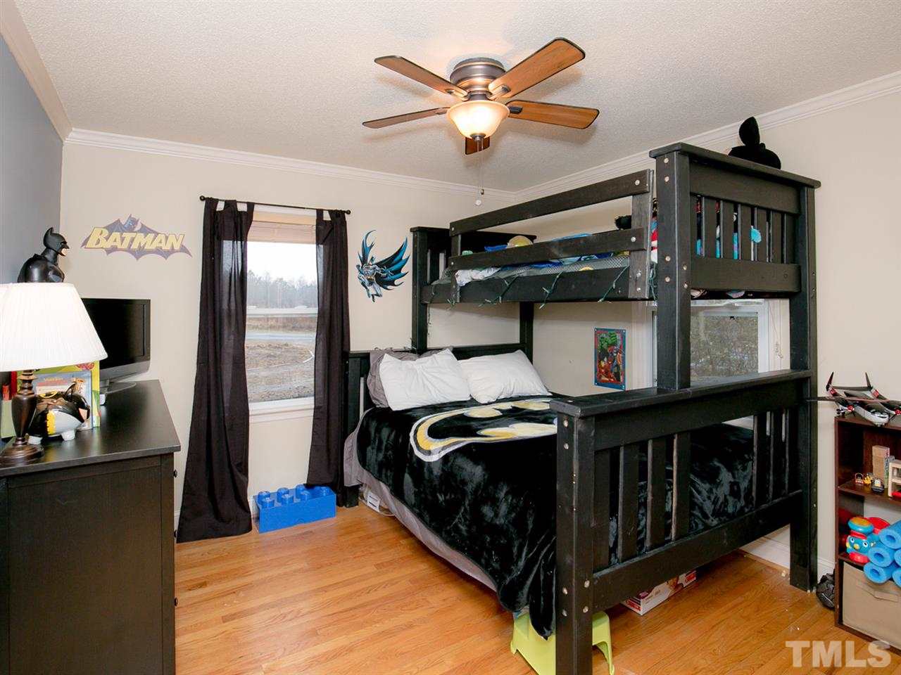 3628 Edgemont Road Wendell, NC 27591 - Photo 16 of 17 a bedroom with a bed and a chandelier