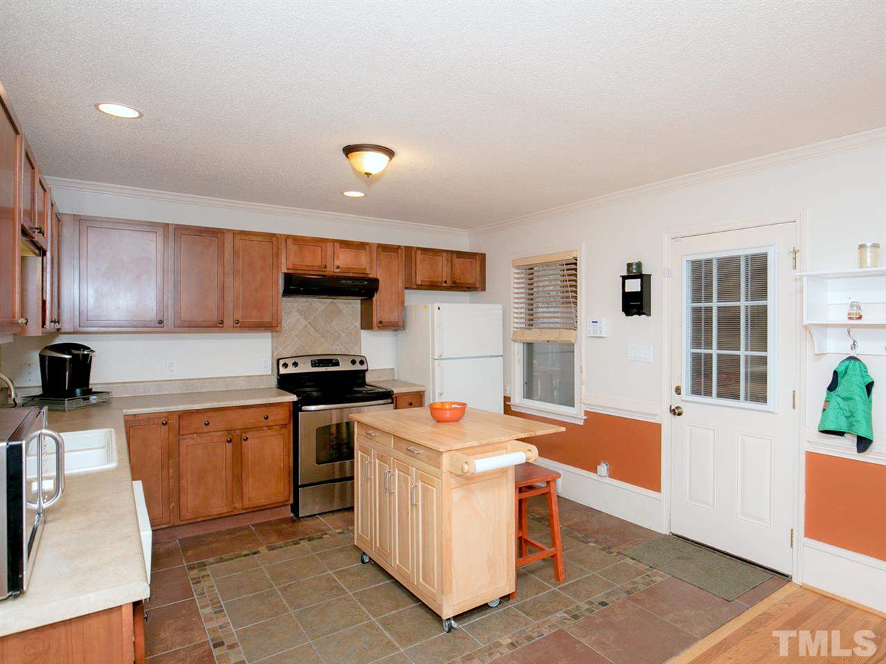 3628 Edgemont Road Wendell, NC 27591 - Photo 3 of 17 a kitchen with stainless steel appliances granite countertop a stove top oven a sink dishwasher and white cabinets with wooden floor