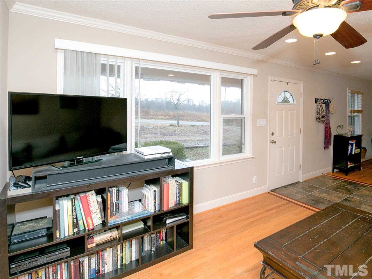 3628 Edgemont Road Wendell, NC 27591 - Photo 8 of 17 a living room with flat screen tv and a book shelf