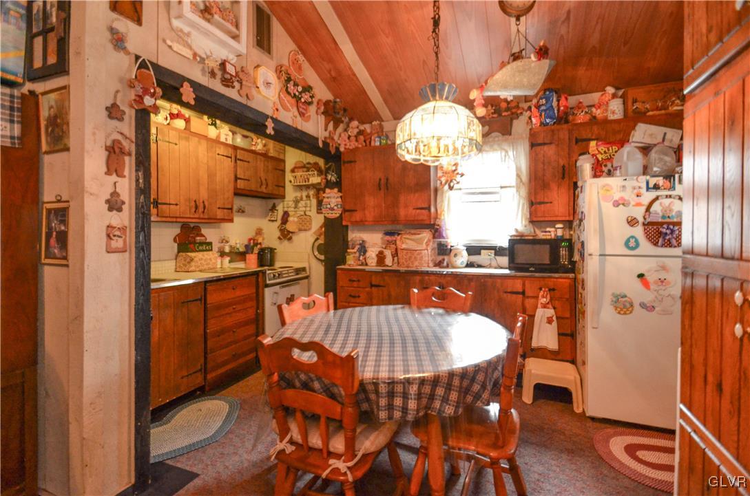 206 Eastbrook Road Effort, PA 18330 - Photo 5 of 13 a view of a dining room with furniture a chandelier and wooden floor