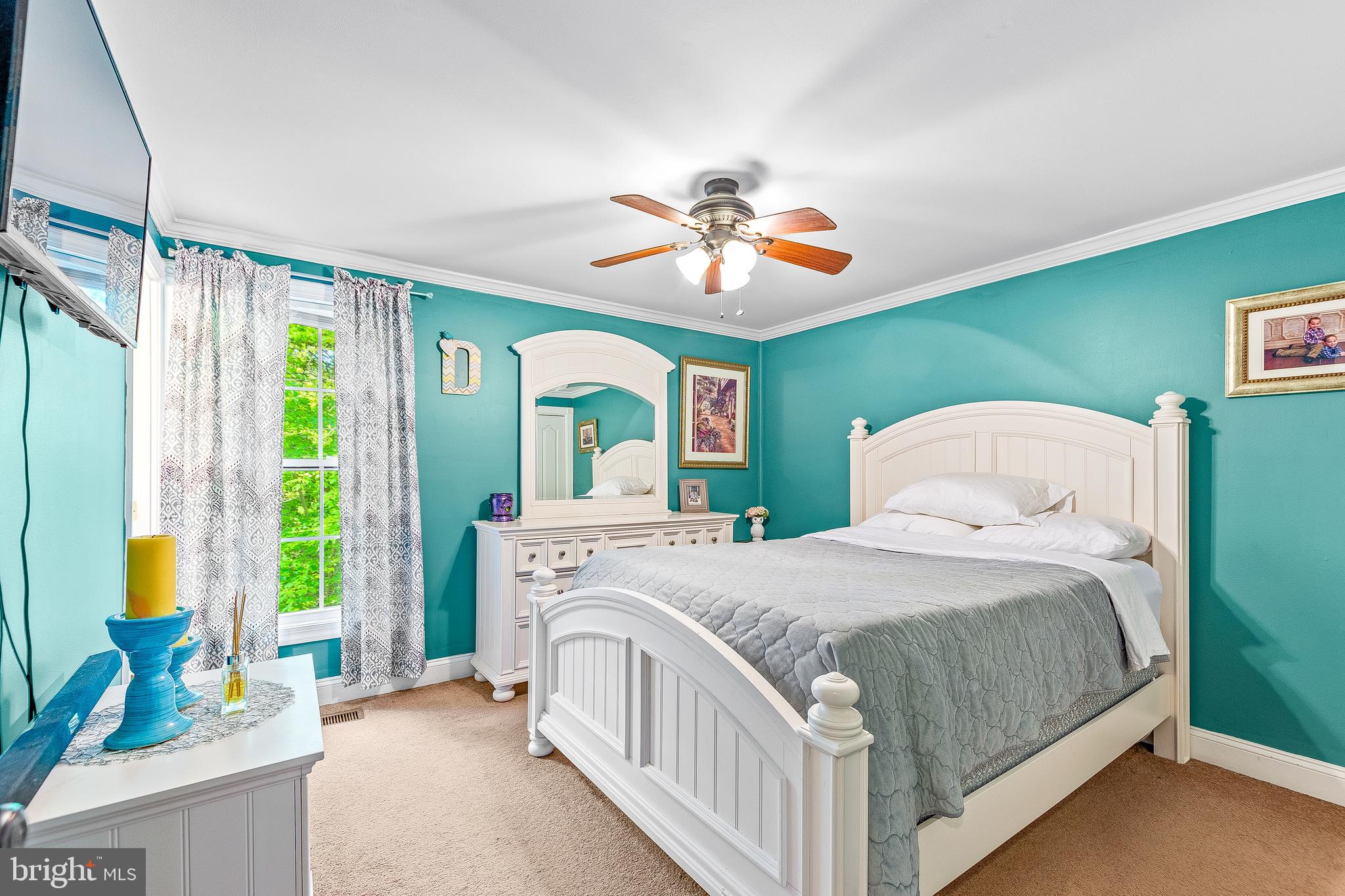 12435 Ridge Road Lusby, MD 20657 - Photo 22 of 25 a bedroom with a bed and a chandelier