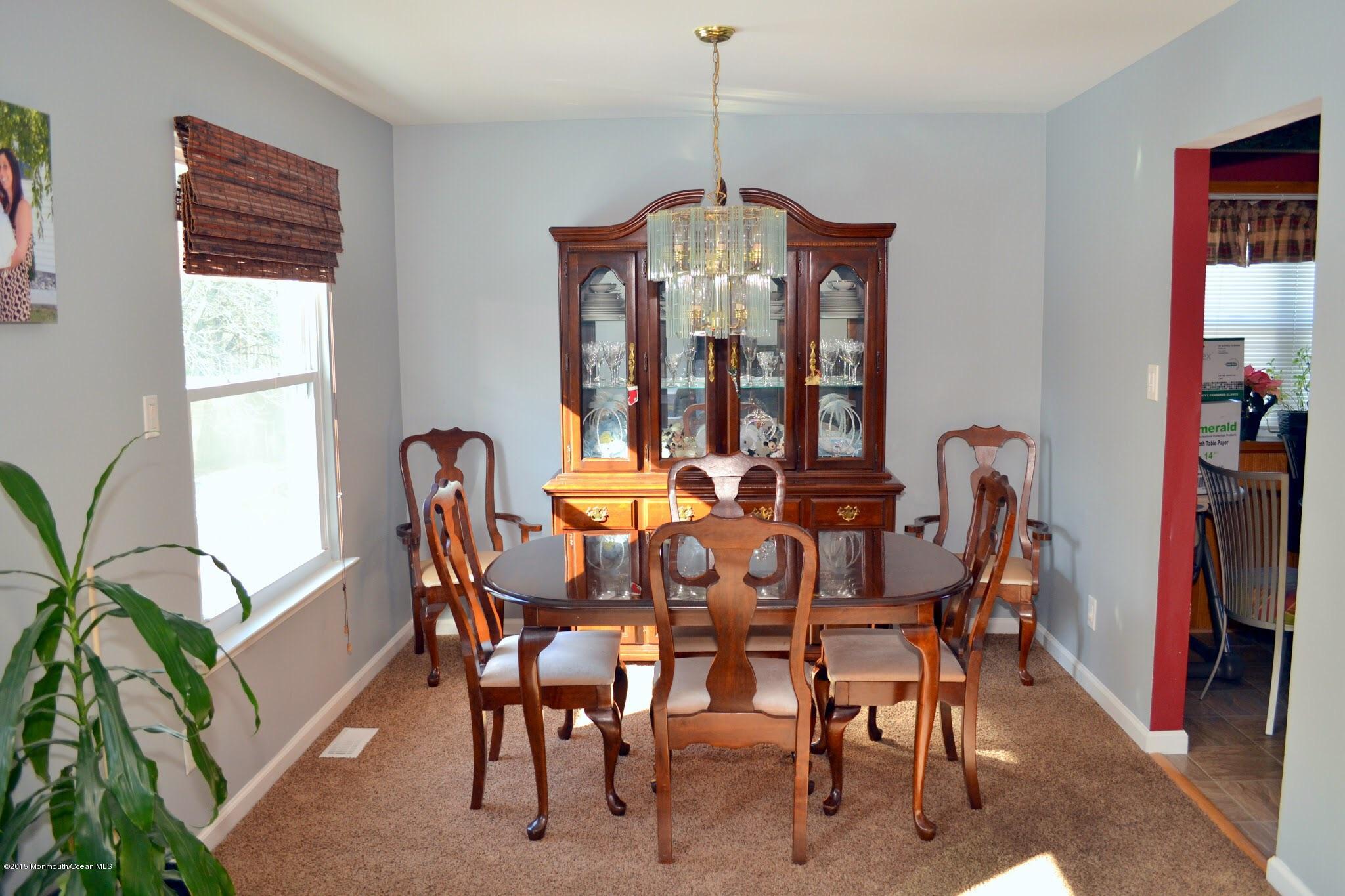 93 Starlight Road Howell, NJ 07731 - Photo 15 of 28 a view of a dining room with furniture and a potted plant