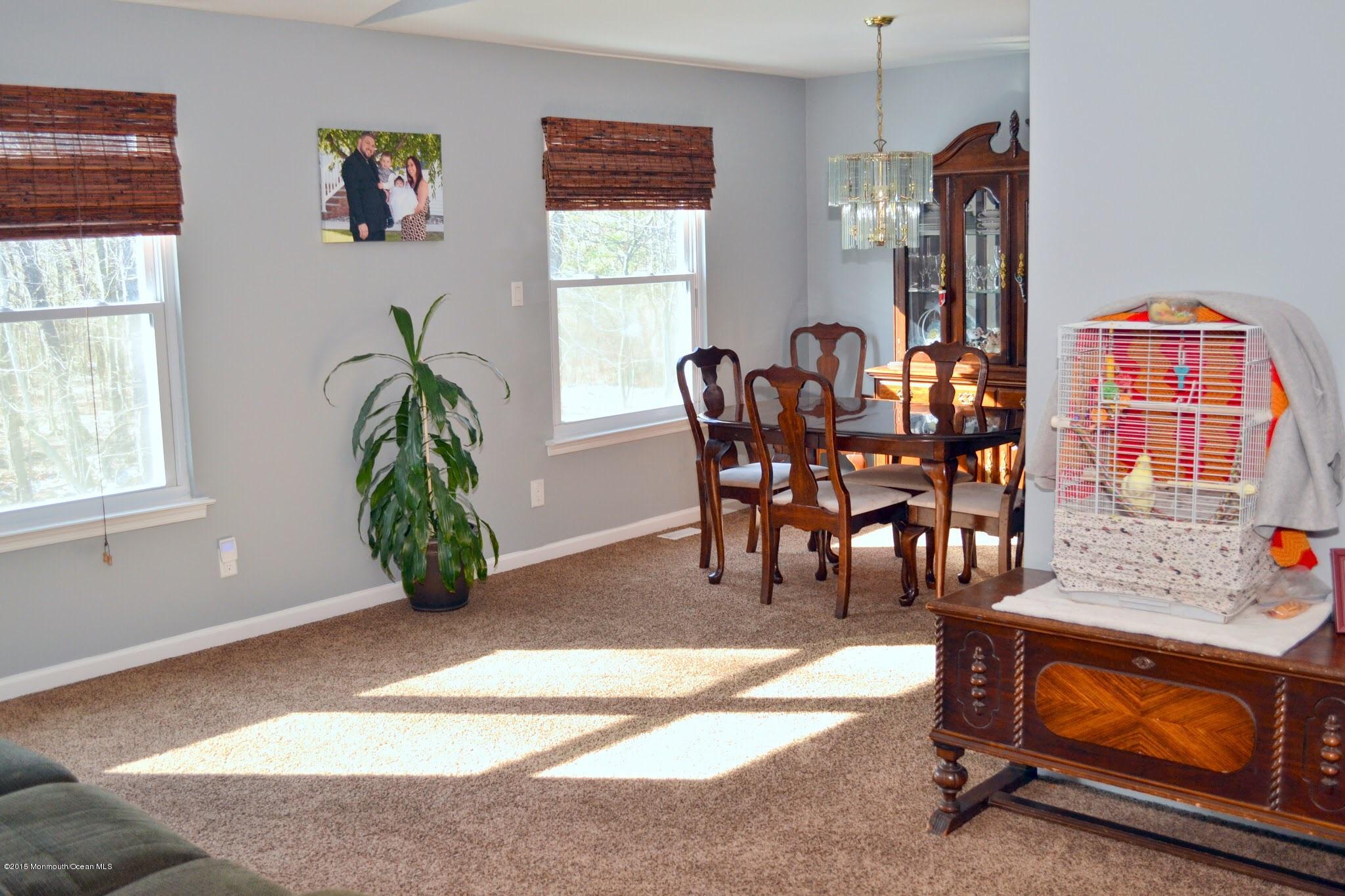 93 Starlight Road Howell, NJ 07731 - Photo 16 of 28 a view of a dining room with furniture and a potted plant