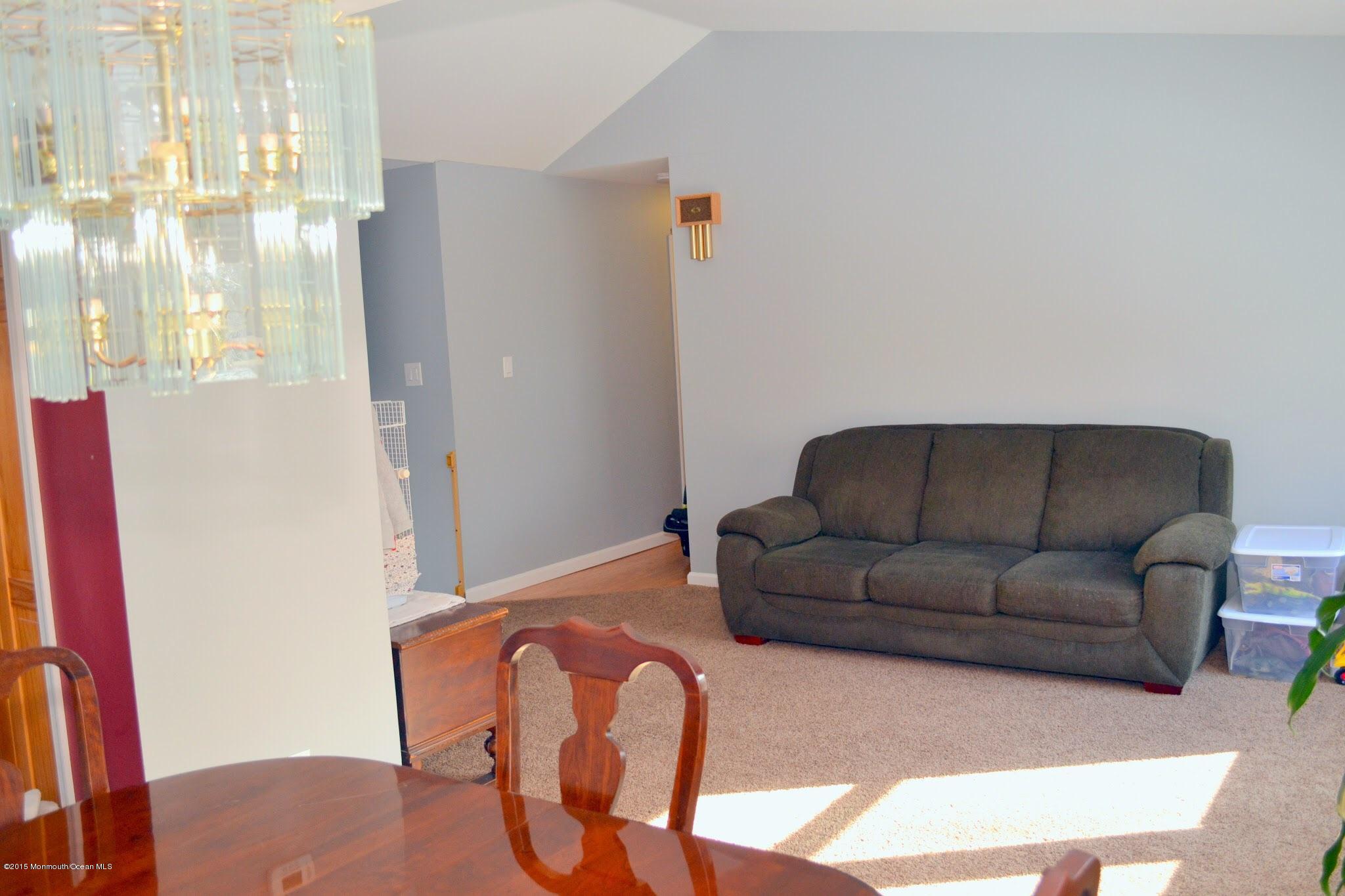 93 Starlight Road Howell, NJ 07731 - Photo 17 of 28 a living room with furniture and a rug