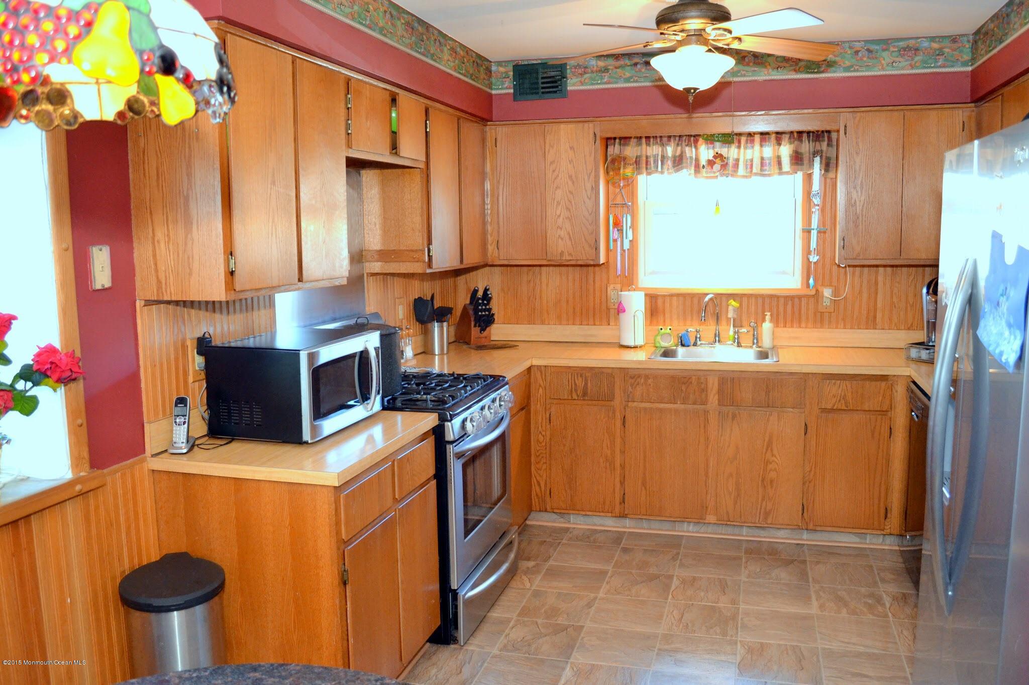93 Starlight Road Howell, NJ 07731 - Photo 18 of 28 a kitchen that has a sink and a stove