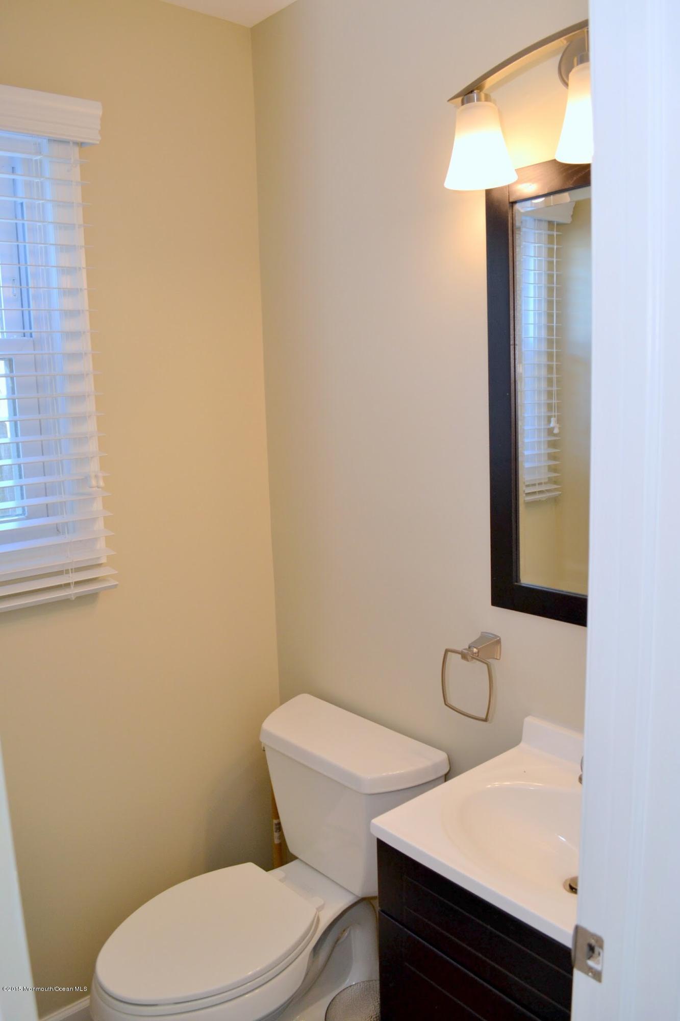 93 Starlight Road Howell, NJ 07731 - Photo 20 of 28 a white toilet sitting next to a bathroom sink