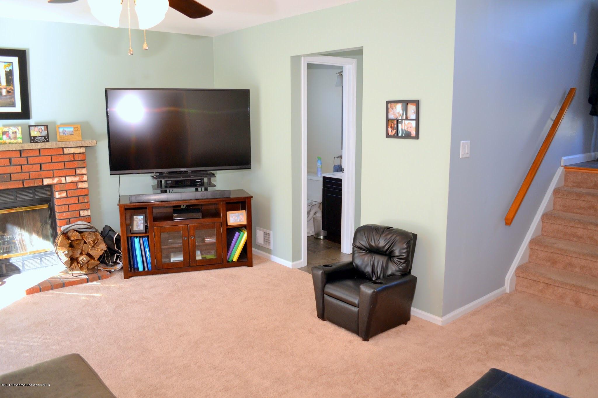 93 Starlight Road Howell, NJ 07731 - Photo 22 of 28 a living room with furniture and a flat screen tv