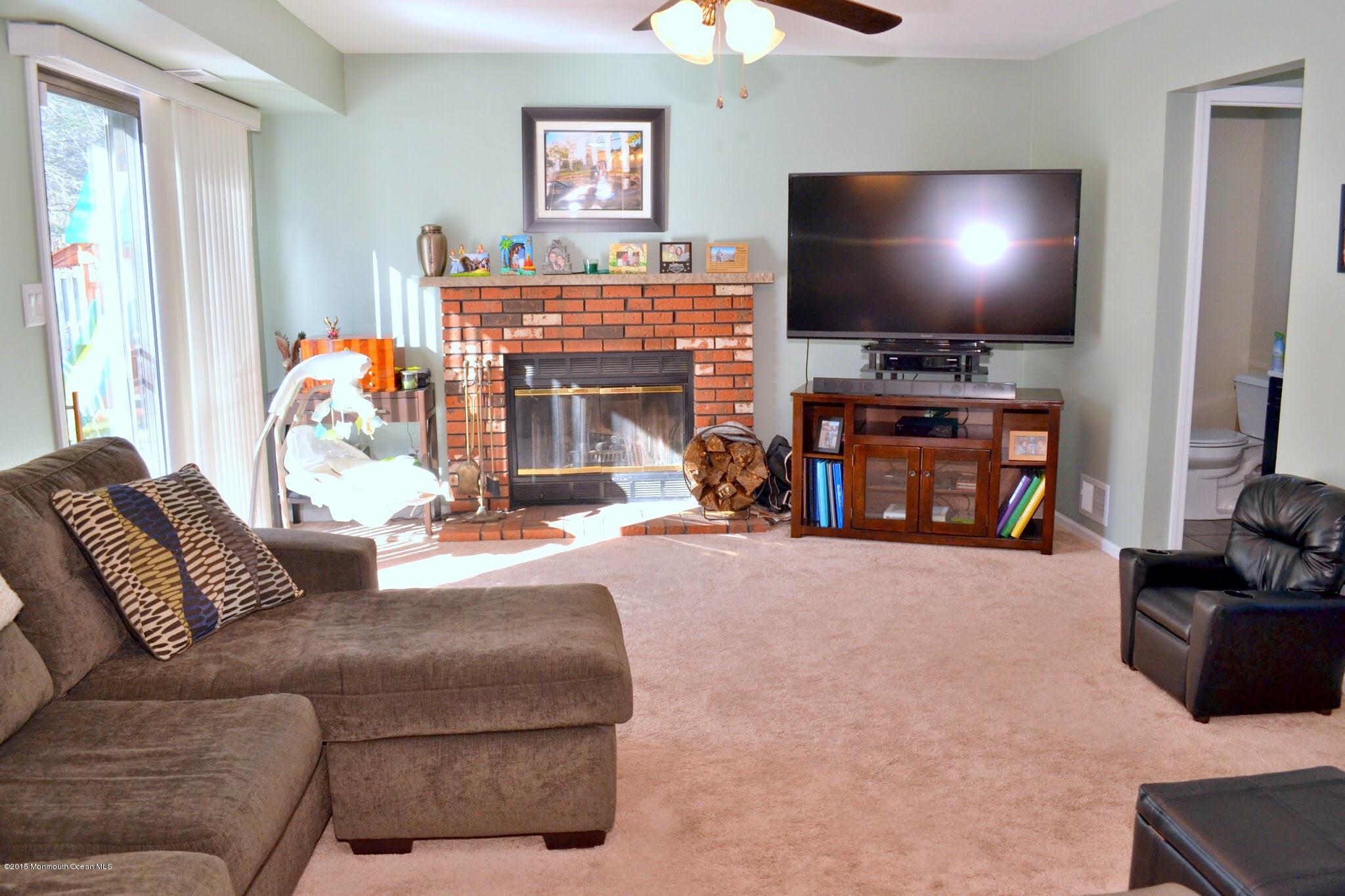 93 Starlight Road Howell, NJ 07731 - Photo 23 of 28 a living room with furniture and a flat screen tv