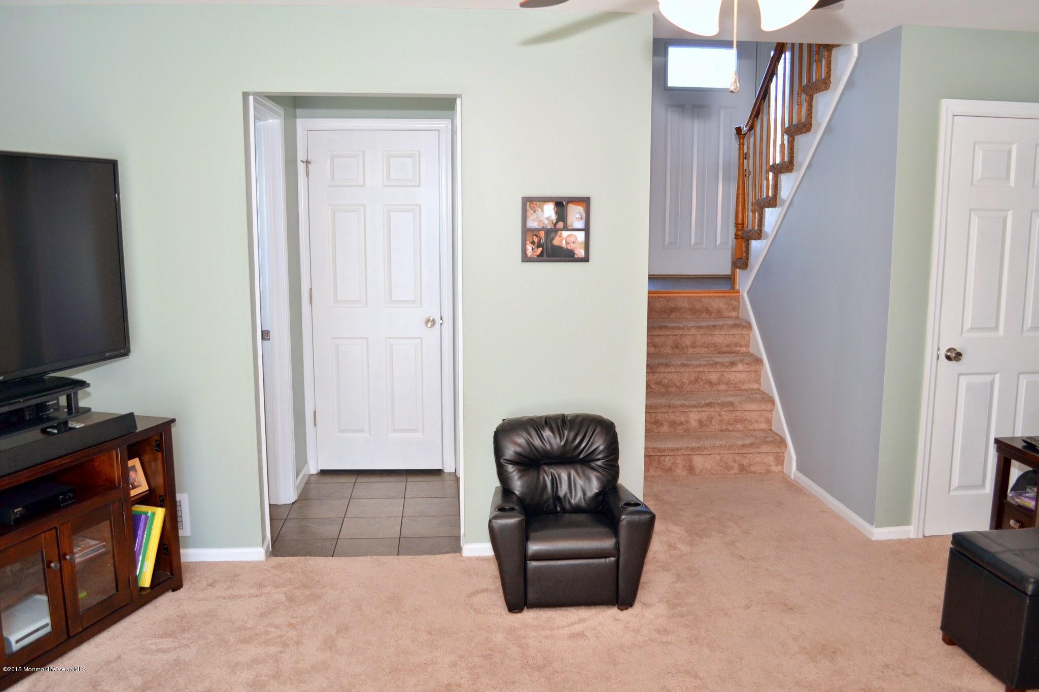93 Starlight Road Howell, NJ 07731 - Photo 24 of 28 a living room with furniture and a flat screen tv
