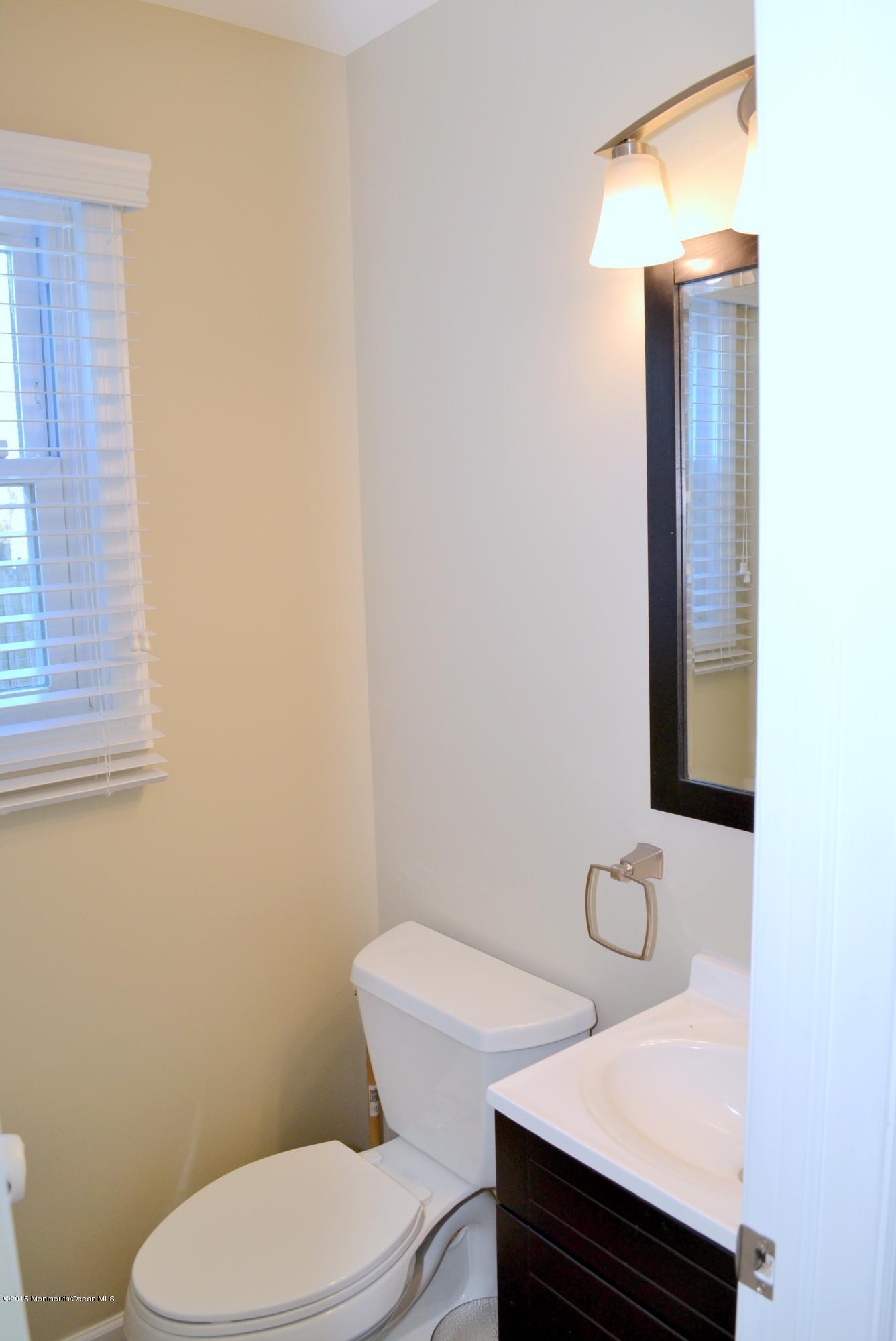 93 Starlight Road Howell, NJ 07731 - Photo 28 of 28 a white toilet sitting next to a bathroom sink