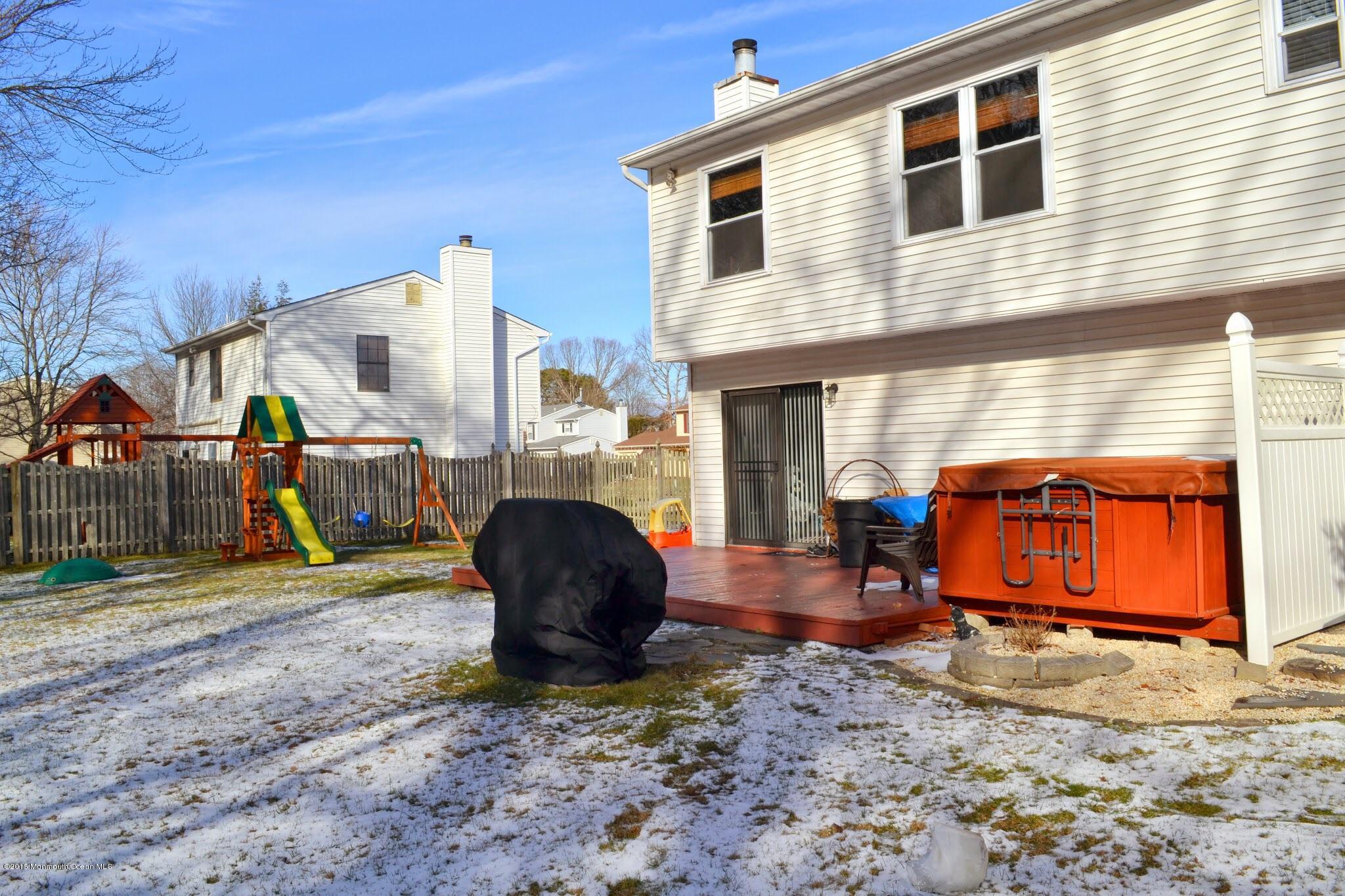 93 Starlight Road Howell, NJ 07731 - Photo 5 of 28 a backyard of a house with barbeque oven table and chairs