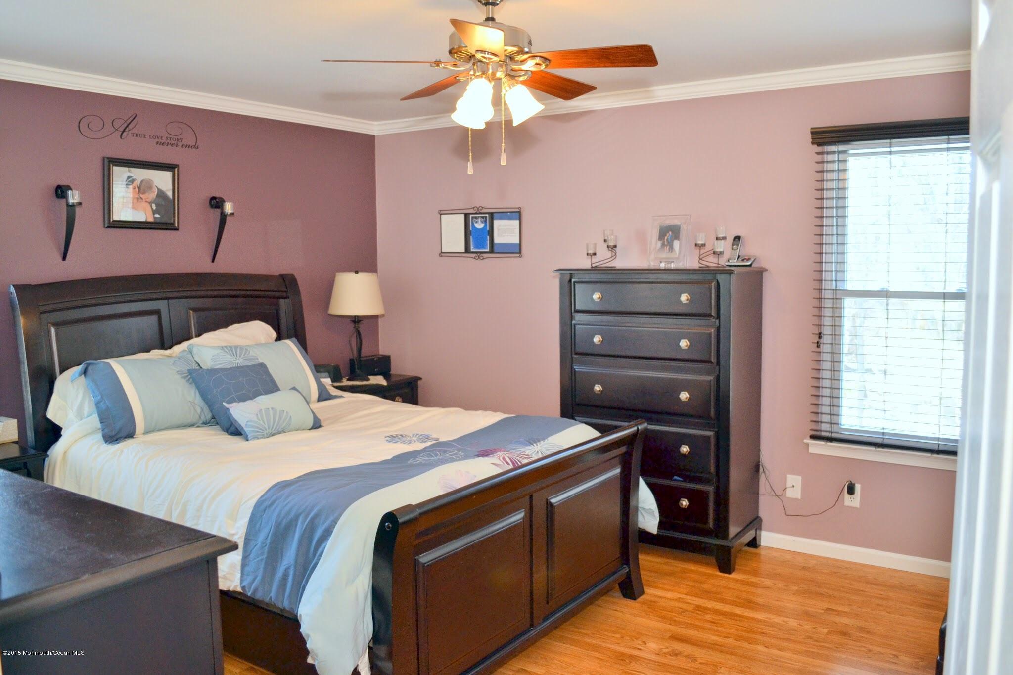 93 Starlight Road Howell, NJ 07731 - Photo 6 of 28 a bed room with a bed and a chandelier