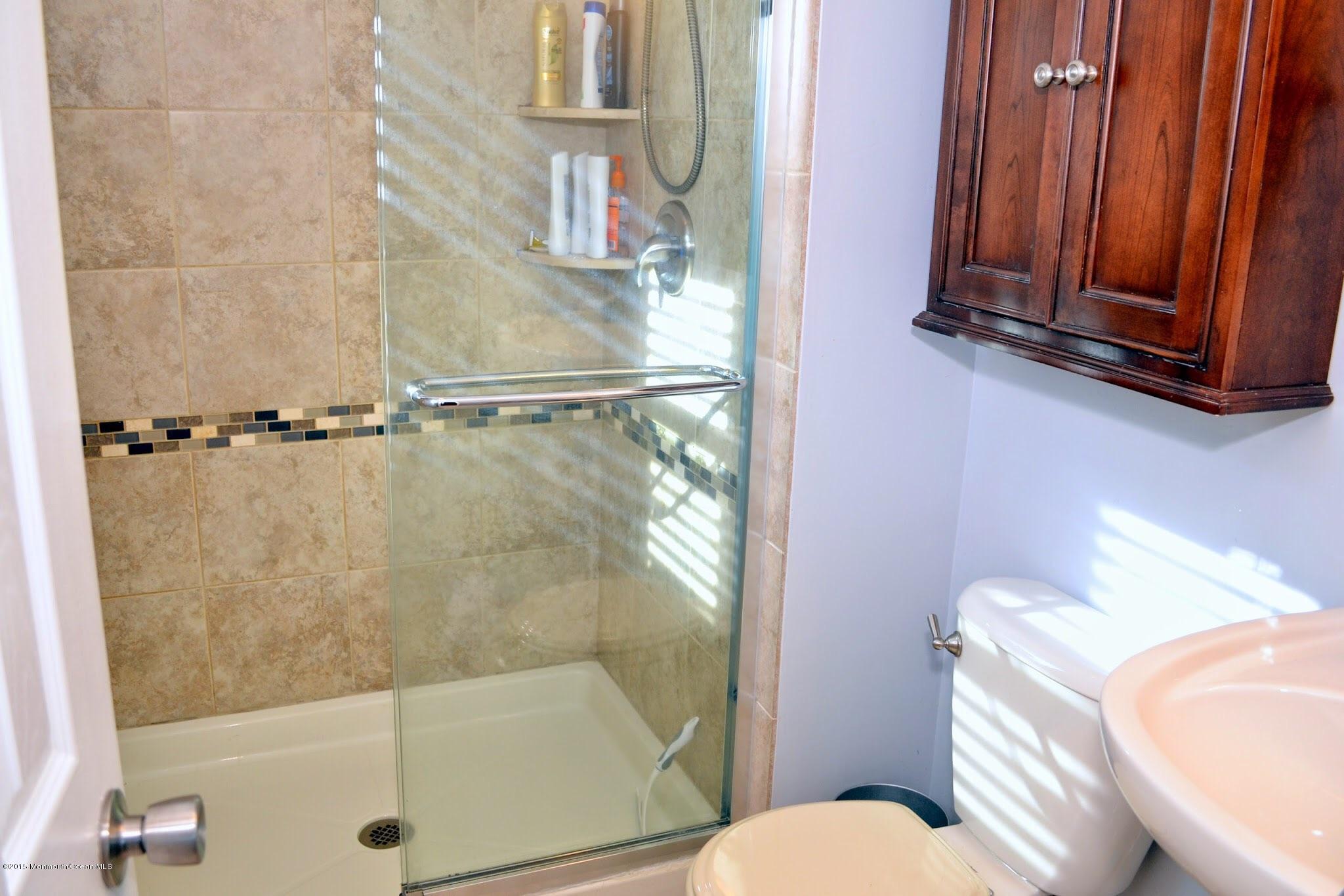 93 Starlight Road Howell, NJ 07731 - Photo 7 of 28 a bathroom with a sink a toilet and shower