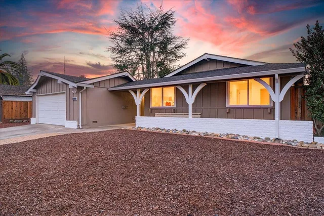 a view of a dining room with furniture and a chandelier