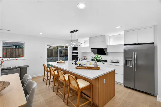 a front view of house with yard and trees in the background