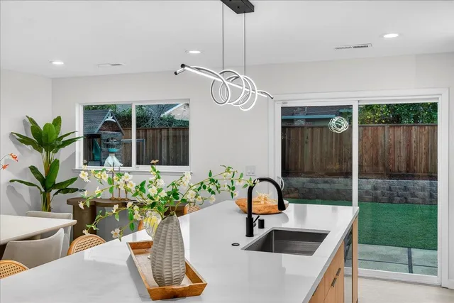 a kitchen with stainless steel appliances a sink a stove and cabinets