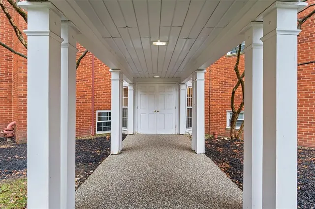 a view of a room with a large window and front door