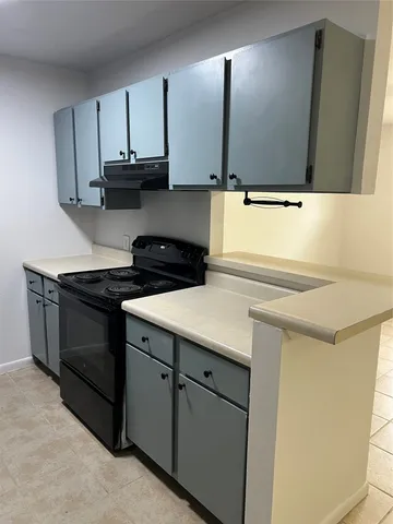 a kitchen with a sink and a refrigerator