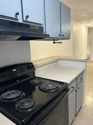 a kitchen with stainless steel appliances a sink a stove a microwave a counter top and cabinets