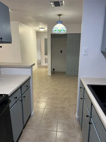 a stove top oven sitting inside of a kitchen