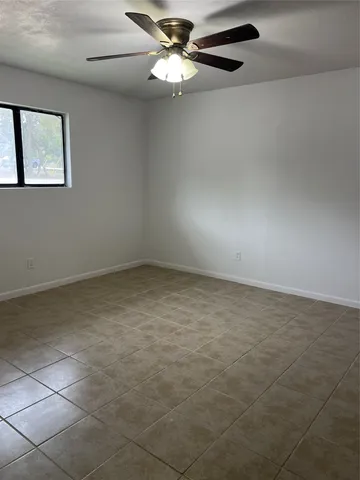 a view of a kitchen with kitchen island a sink stainless steel appliances and cabinets