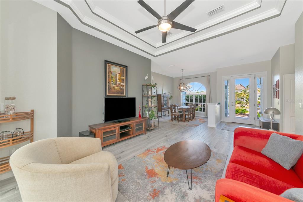 1019 Scherer Way Osprey, FL 34229 - Photo 11 of 56 a living room with furniture and a flat screen tv